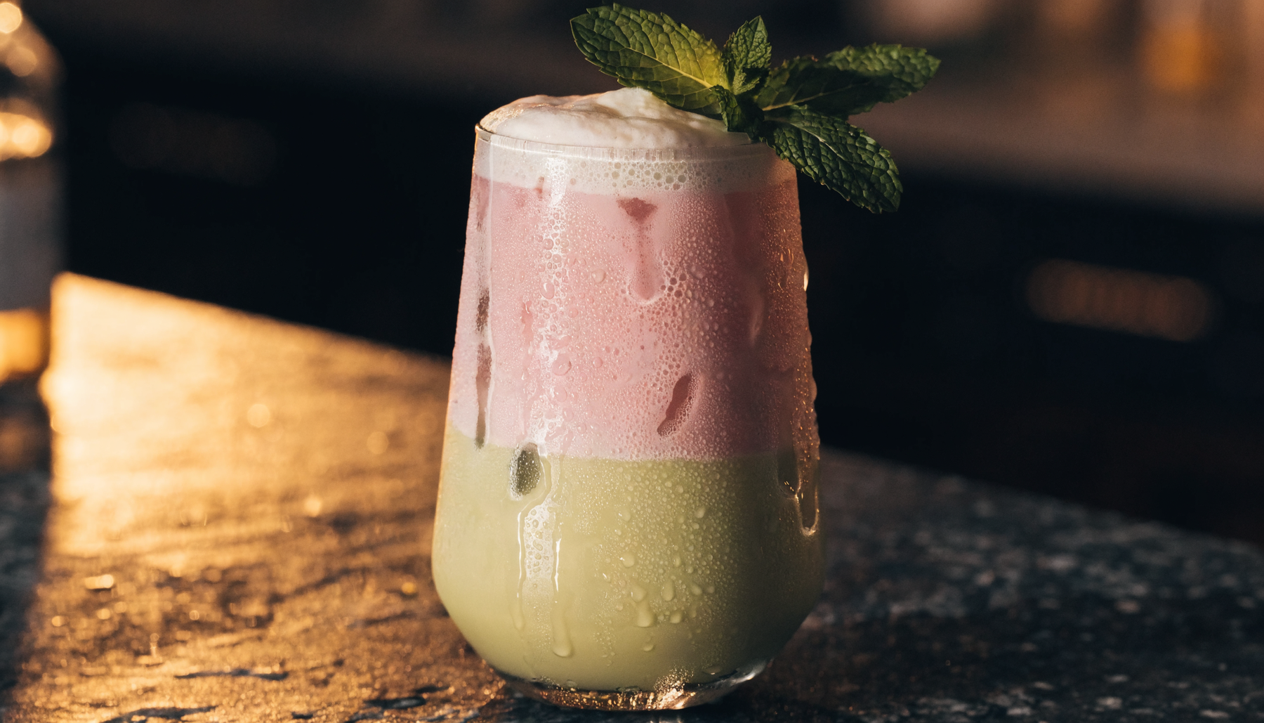 Iced summer drink with pistachio and rose tones on a dark bar | Addtocart Dubai UAE