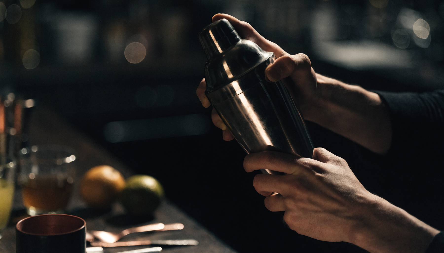 Bartender shaking a cocktail under dramatic competition light | Addtocart Dubai UAE