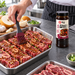 Beef short ribs being marinated with Beksul galbi sauce