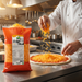 Arla Shredded Cheddar 2KG chef sprinkling pizza preparation | Addtocart Dubai UAE